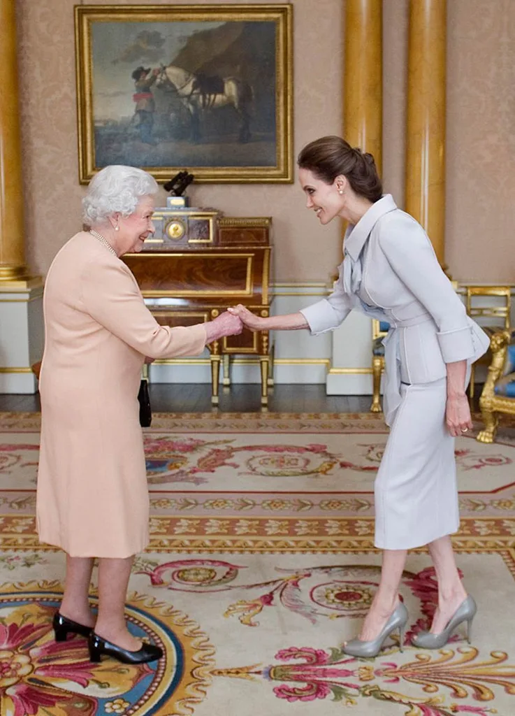 Angelina Jolie meeting Queen Elizabeth II in 2014.