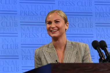 Grace Tame speaking at podium