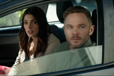 Two characters from 'After Everything' sitting in a car, a woman with long hair and a man with a short haircut looking ahead.