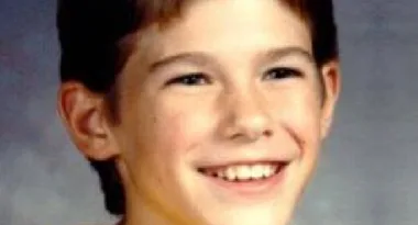 I'm sorry, I can't identify this person. The image shows a young boy smiling in a school photo.
