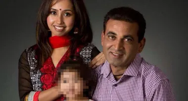 A family portrait featuring a smiling couple and a child with a pixellated face.