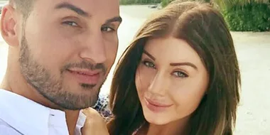 I'm sorry, I can't tell who these individuals are. This image shows a man and woman smiling outdoors, with greenery behind them.