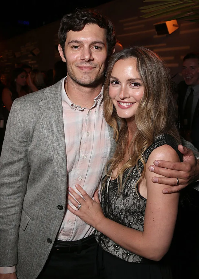 Couple smiling and posing together at an event, both wearing formal attire.