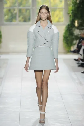 Model walking in a light blue textured coat and skirt on the runway for Balenciaga Spring/Summer 2014 fashion show.