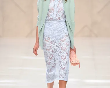 Model in Burberry SS14 outfit: mint cardigan, lace dress, pink clutch and heels, walking on runway.