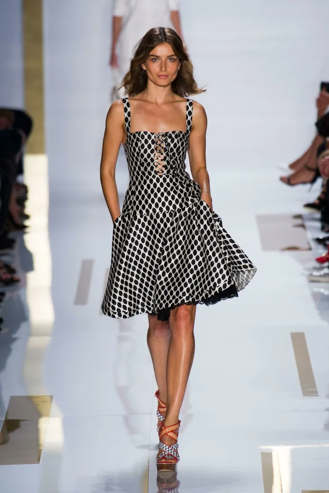 Model wearing a black and white patterned dress on the runway at Diane von Furstenberg SS14 fashion show.