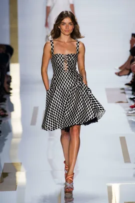 Model wearing a black and white patterned dress on the runway at Diane von Furstenberg SS14 fashion show.