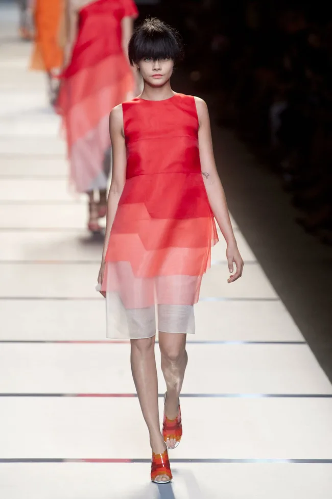 Model in a red gradient dress walks the runway at Fendi SS14 fashion show.