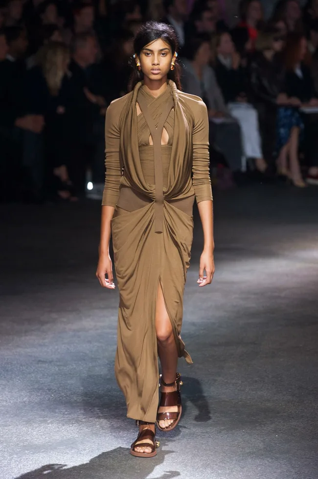 Model in a brown draped gown and sandals walks Givenchy Spring/Summer 2014 runway.