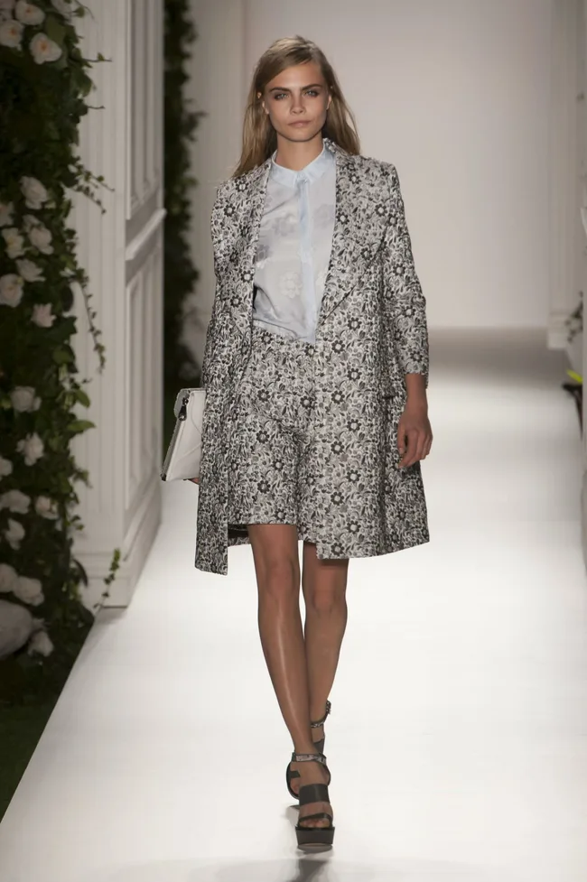 Model walks runway in floral-patterned coat and skirt set at Mulberry Spring/Summer 2014 fashion show.