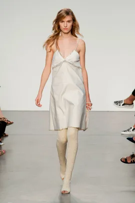 Model in a white slip dress and lace leggings walks down the runway at Thakoon Spring/Summer 2014 fashion show.