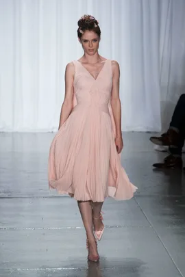 Model in light pink pleated dress walks runway at Zac Posen SS14 fashion show.