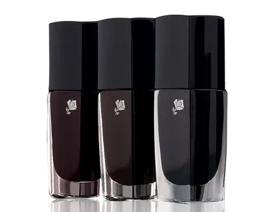 Three bottles of Lancôme nail polish in shades of black, displayed in a row.