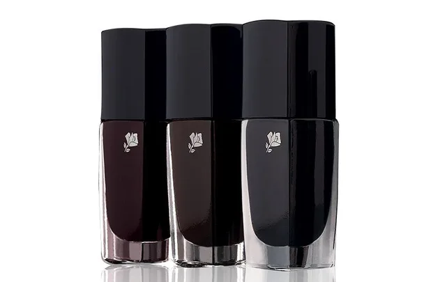 Three bottles of Lancôme nail polish in shades of black, displayed in a row.