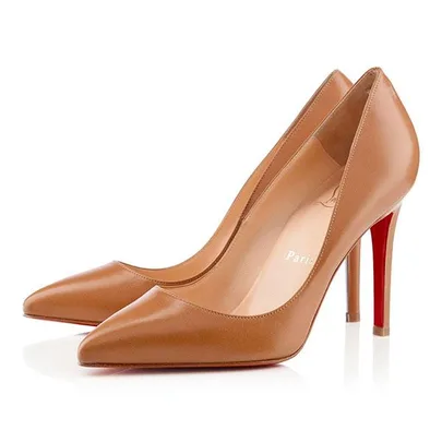 "Pair of tan Christian Louboutin high heels with signature red soles"