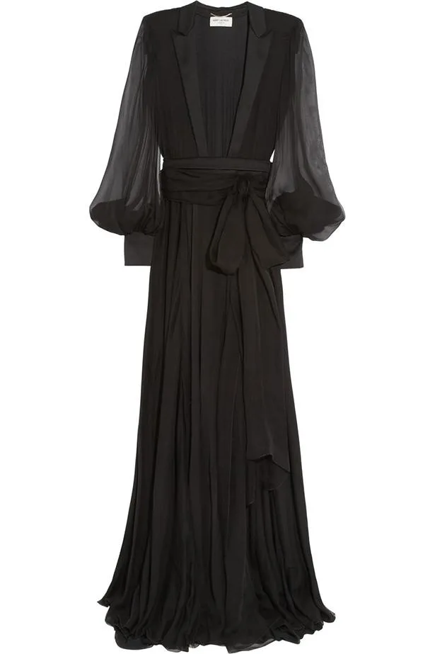 Black sheer Saint Laurent gown with flowing sleeves and tied sash, featuring a long, elegant silhouette.