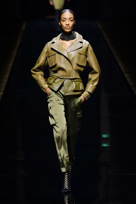 Model in an olive green leather jacket and cargo pants on Balmain AW14/15 runway.