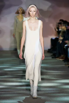 Model walking in Marc Jacobs Fall 2014 runway show, wearing a white dress and headband.