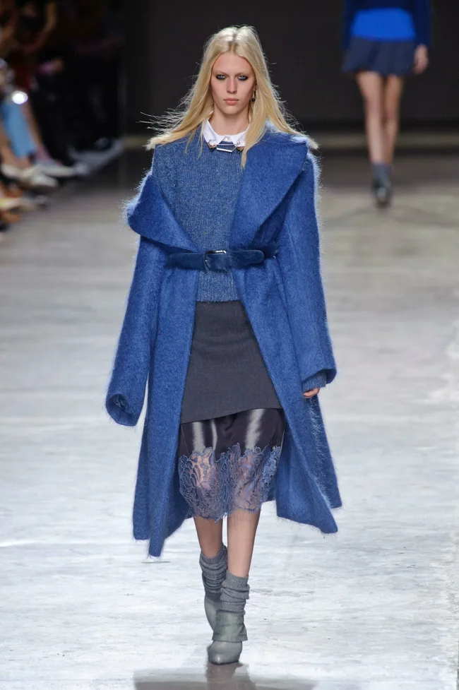 Model in blue coat and grey dress on Topshop Unique runway, AW14-15 collection.