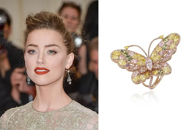 Woman in an elegant dress with red lipstick, wearing earrings, next to an ornate butterfly-shaped ring.