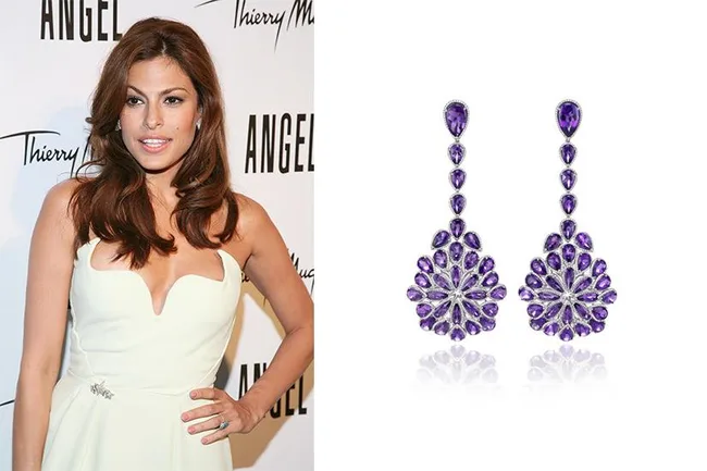 Young woman in white dress poses at an event; next to her are ornate purple gemstone earrings.