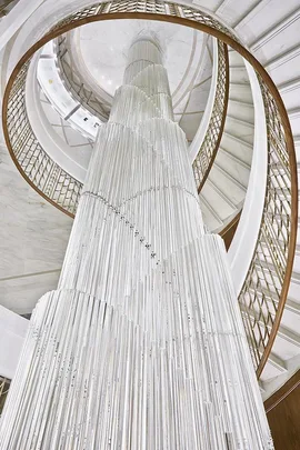 Spiral staircase with elegant white and gold design in Tiffany & Co.'s new Parisian store.