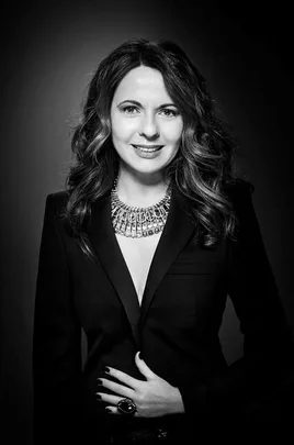 Black and white photo of Nathalie Colin, Swarovski's Global Creative Director, in a blazer with a statement necklace.