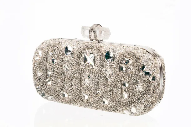 A sparkling Marchesa clutch embellished with intricate crystal designs and a unique geometric clasp.