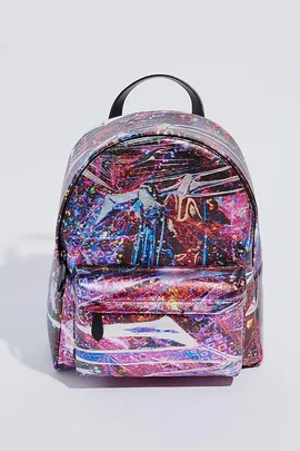 A multicolored, abstract-patterned backpack with a front pocket and a black handle on top against a plain background.