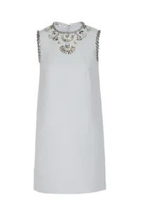 Light blue sleeveless shift dress with intricate jeweled embellishments around the neckline.