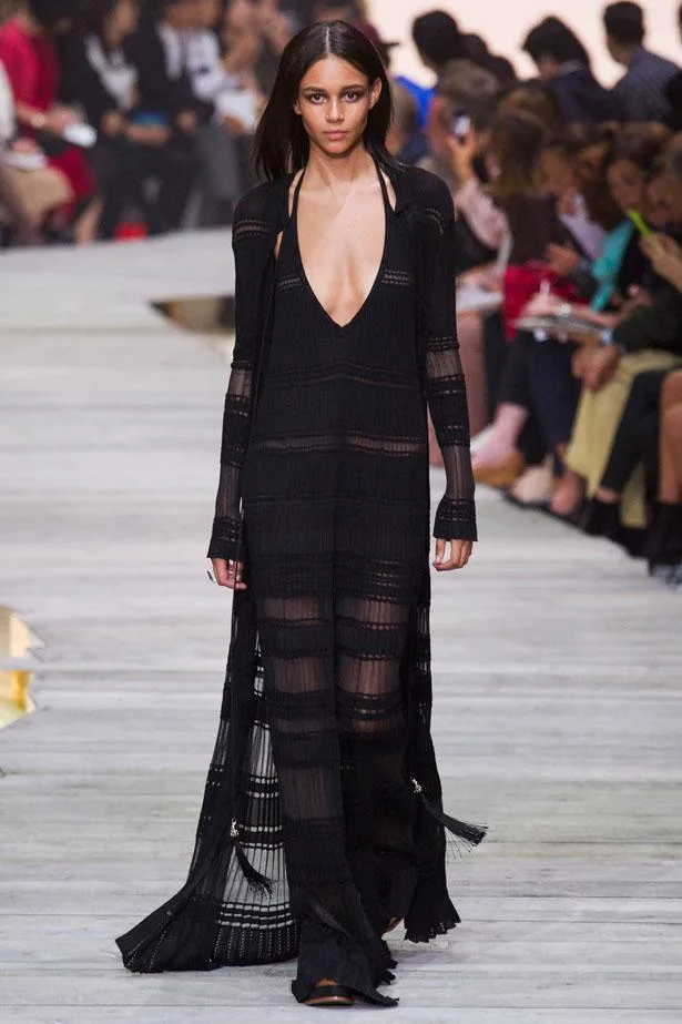 Model walking in a Roberto Cavalli black sheer dress on a runway, Spring/Summer 2015 collection.