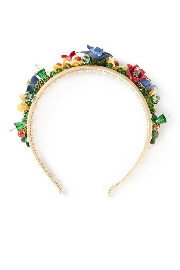 Bejeweled headband with colorful gems and flower embellishments on a cream band.