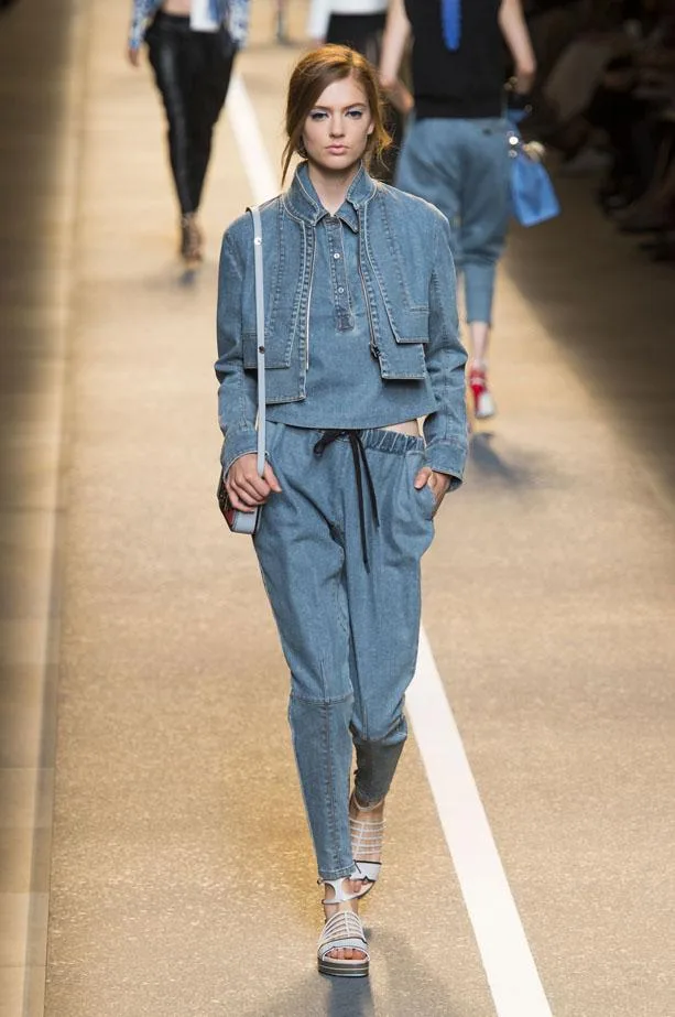 Model walking runway in denim outfit at Fendi Spring/Summer 2015 fashion show.