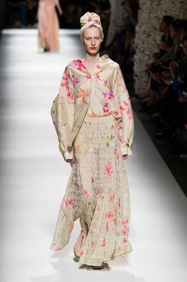 Model in floral-patterned outfit and headscarf on runway, wearing beige and pink, during Missoni Spring/Summer 2015 show.