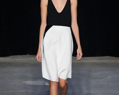 Model walks the runway in a black and white dress from Narciso Rodriguez's Spring/Summer 2015 collection.