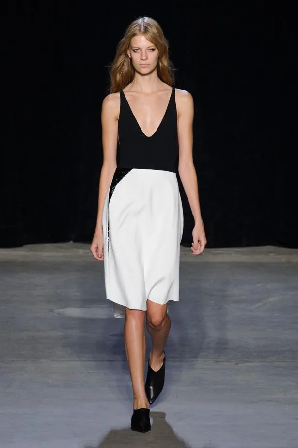 Model walks the runway in a black and white dress from Narciso Rodriguez's Spring/Summer 2015 collection.