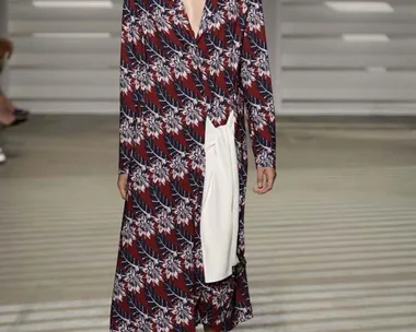 Model in floral long coat with a plunging neckline walks the runway, wearing platform sandals at Thakoon SS15.