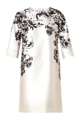 White dress with elbow-length sleeves featuring a black floral pattern across the top and sides.