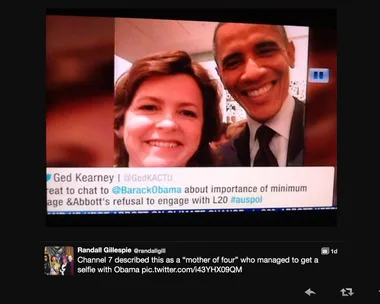 A woman takes a selfie with former President Barack Obama, both smiling at the camera.