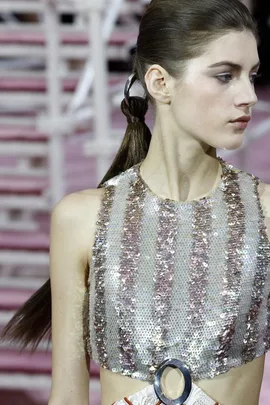 Model with sleek ponytail and shimmery pink and silver striped top at Dior Couture Spring 2015 show.