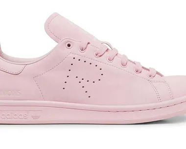 Pink Adidas Raf Simons sneaker with an "R" perforated on the side, viewed from the side profile against a white background.