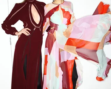 Two models in vibrant Zimmermann dresses pose against a plain background at the AW15-16 fashion event.