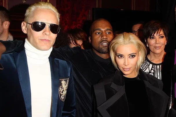 Jared Leto in sunglasses and Kim Kardashian with blonde hair, joined by Kanye West and others at an event.