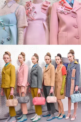 Models in pastel Prada outfits with colorful handbags and floral embellishments on coats at Milan Fashion Week.