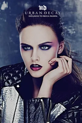 Woman with dramatic makeup in a black and silver jacket, featuring Urban Decay exclusive to Mecca Maxima.