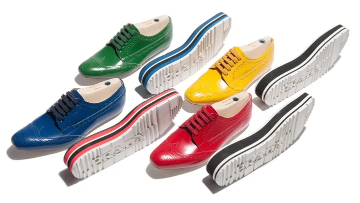 Prada's colorful Derby shoes with thick white soles in green, blue, yellow, and red, displayed with matching raised soles.