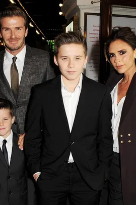 David Beckham, Victoria Beckham, and their children pose together in formal attire.