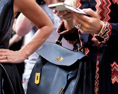 A woman on her phone at Fashion Week