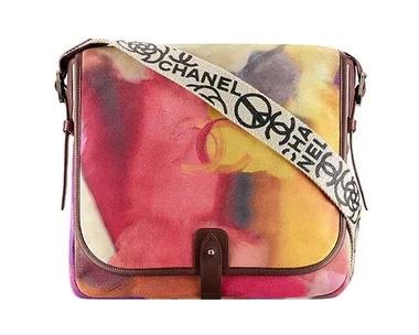 Chanel multicolored messenger bag with a printed strap featuring the Chanel logo and symbols.