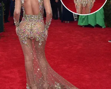 Woman in a sparkling, floral, sheer gown on the red carpet, showcasing the intricate back and trailing train design.